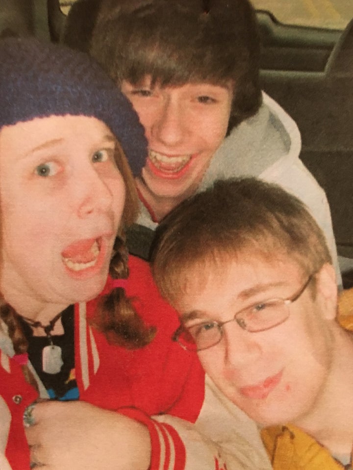 Undated photograph of Joe (bottom right) with sister, Kim (left), and brother, Travis (top).