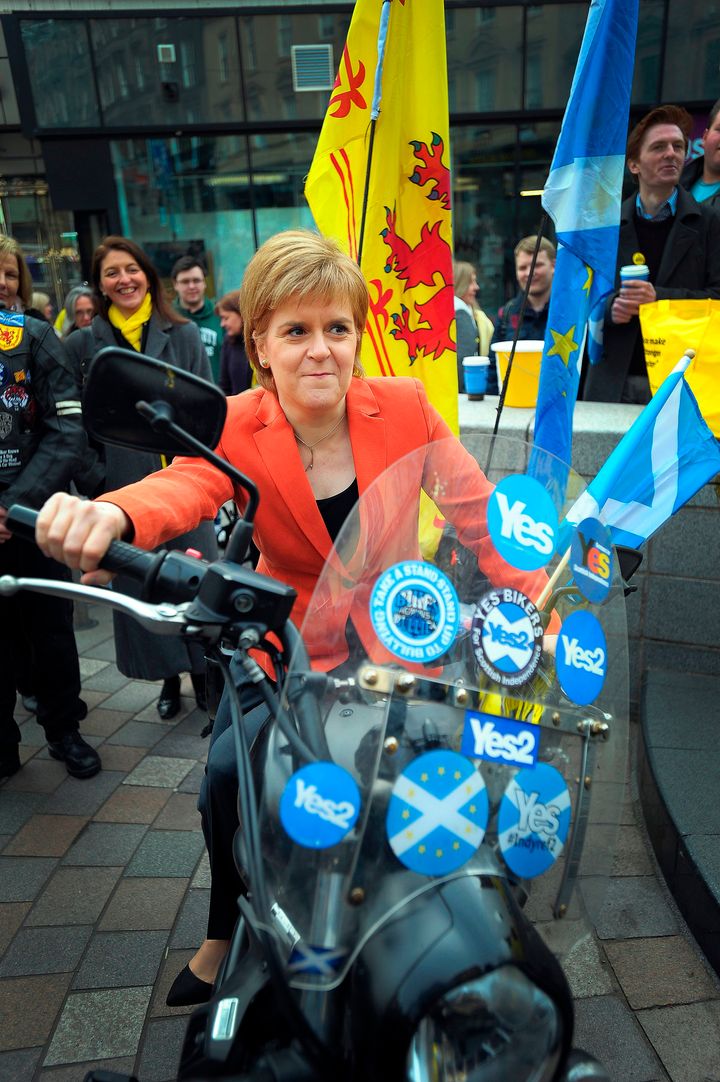 First Minister of Scotland, and leader of the Scottish National Party (SNP), Nicola Sturgeon MSP, poses on a motorbike decorated with Scottish Saltires and stickers supporting Scottish independence