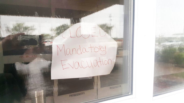 A sign hangs on the door at a La Quinta Inn in Victoria. 