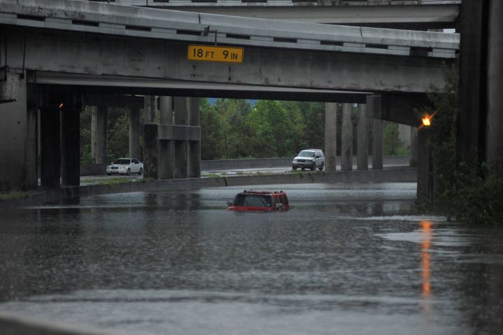 An abandoned Hummer is covered in floodwaters along Interstate 610 in Houston on Sunday.