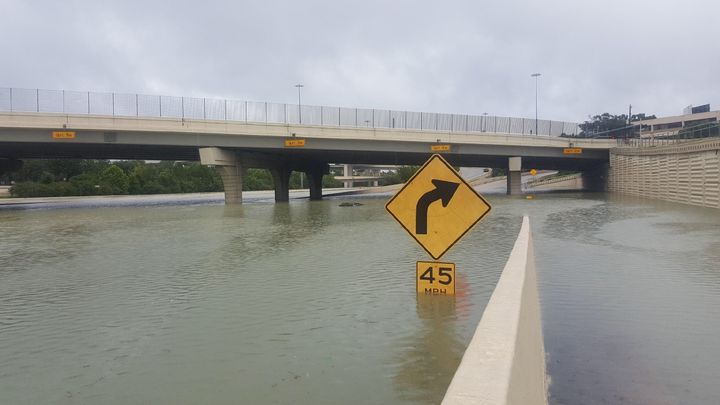 A partially submerged speed limit sign in Katy, Texas, shows how high the floodwaters have reached in some areas.