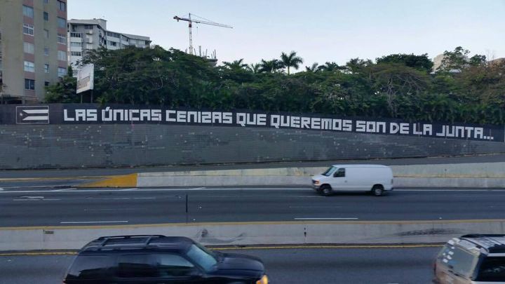 The phrase “Las únicas cenizas que queremos son las de la Junta...” was coined by the arts collective, La Puerta. The collective painted this wall next to the Puerto Rico Museum of Art in the Capital City of San Juan.
