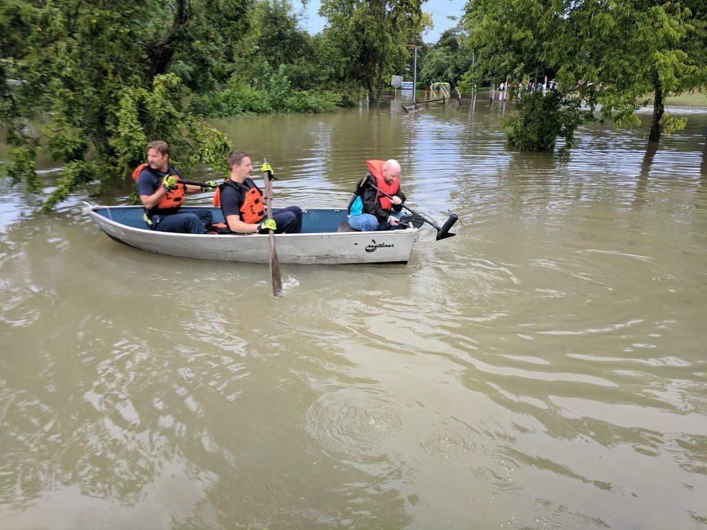 People in a boat following this weekend's heavy rain.