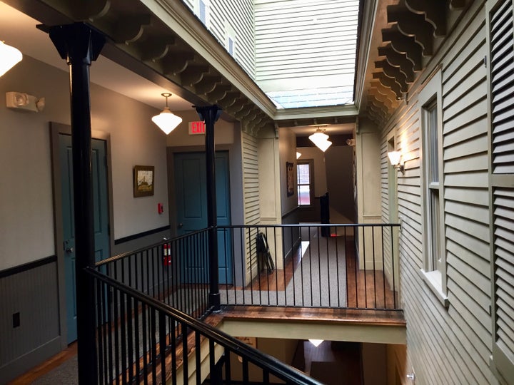 <p>The interior hallways of Porches Inn at Mass MOCA are whimsically designed to look like an exterior.</p>