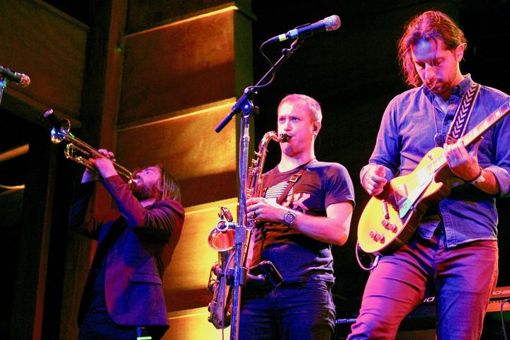 The Revivalists’ Michael Girardot (trumpet), Rob Ingraham (saxophone) and Zack Feinberg (guitar) perform on Aug. 19 at the Folks Festival.