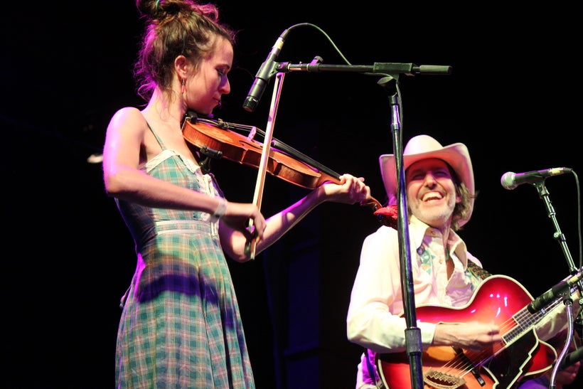 Dave Rawlings (right) enjoys a moment onstage with fiddler Brittany Haas on Aug. 20 at the Folks Festival.
