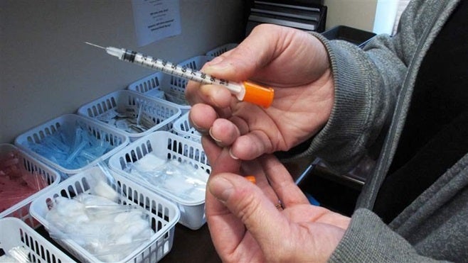 An Indiana nurse holds one of the syringes provided to intravenous drug users taking part in Fayette County’s state-approved needle exchange program. Hepatitis C infections have nearly tripled since 2010 — an increase mainly due to the heroin epidemic.