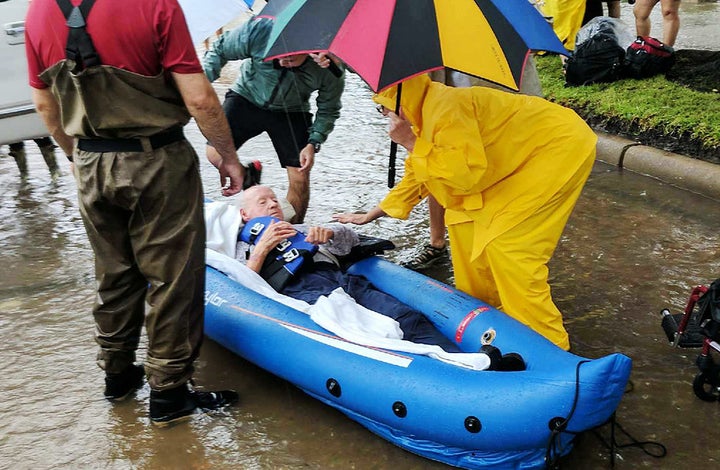 A person is rescued in a Houston neighborhood after water was released to ease overflowing on nearby reservoirs.