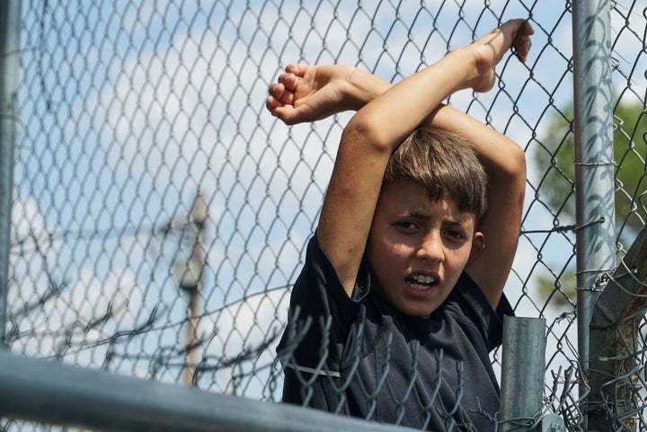 A young refugee boy languishes in the Diavata camp, located in Thessaloniki, Greece, on Aug. 17. More than 50,000 refuge