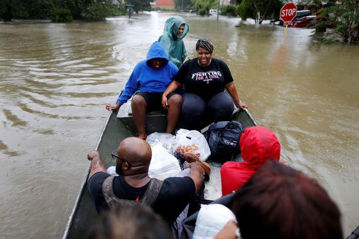 A family is rescued from rising floodwaters in the Beaumont Place community in southeast Texas on Monday.