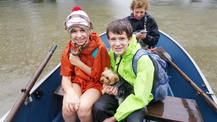 Bobbie, Gracie and Nolen Shumaker boated to safety Monday with their dog Coco in tow.