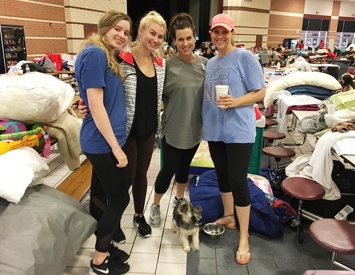 Avery Butler, 17, left, Lauren Irving, 17, Whitney Irving, 45, and Jen Guidry, 37, make the best of their time as evacuees at Cinco Ranch High School in Katy, Texas.
