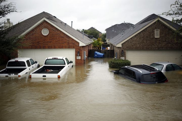 Houses and vehicles at the Highland Glen subdivision stand in floodwaters due to Hurricane Harvey in Spring, Texas, U.S., on Monday, Aug. 28, 2017.