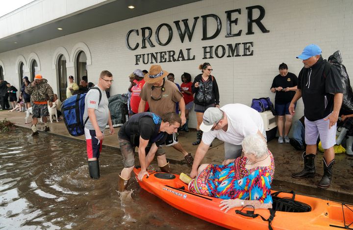People wait to be evacuated from flood waters from Hurricane Harvey in Dickinson, Texas on Aug. 27, 2017.