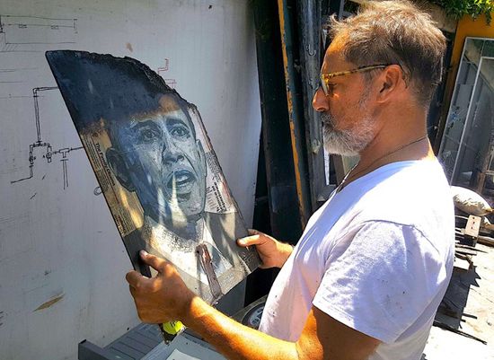 <p>Flavio Alejandro Bisciotti views burned Obama poster </p>