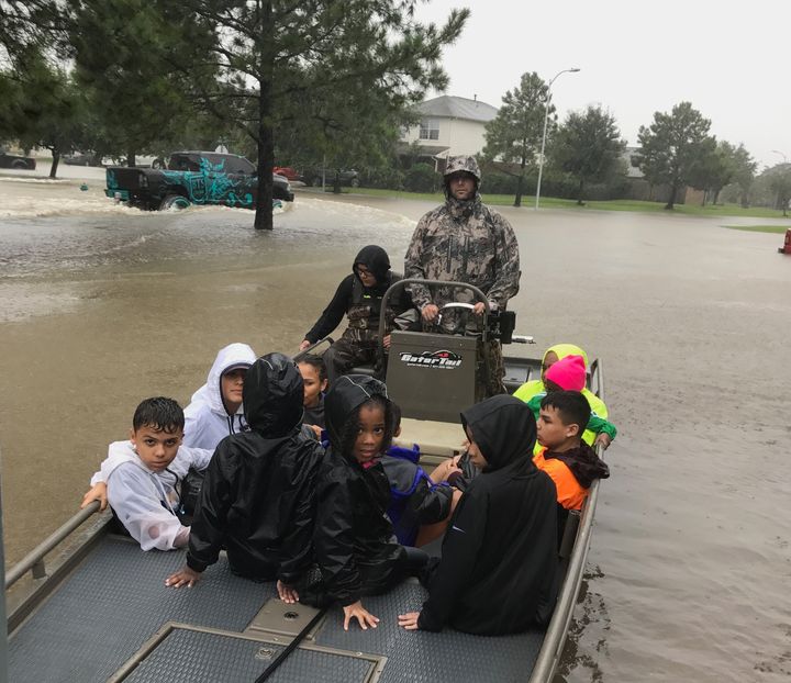 Joe Spell, a volunteer with the "Cajun Navy," ferries children to safety in Houston on Monday.