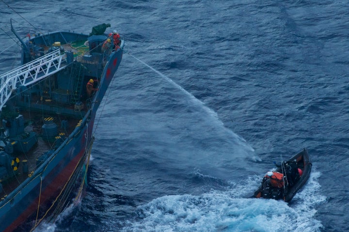 A water canon is sprayed from a Japanese whaling ship towards a small Sea Shepherd boat, about 480 km north of Mawson Peninsula off the coast of Antarctica, in this handout picture released on January 18, 2012.