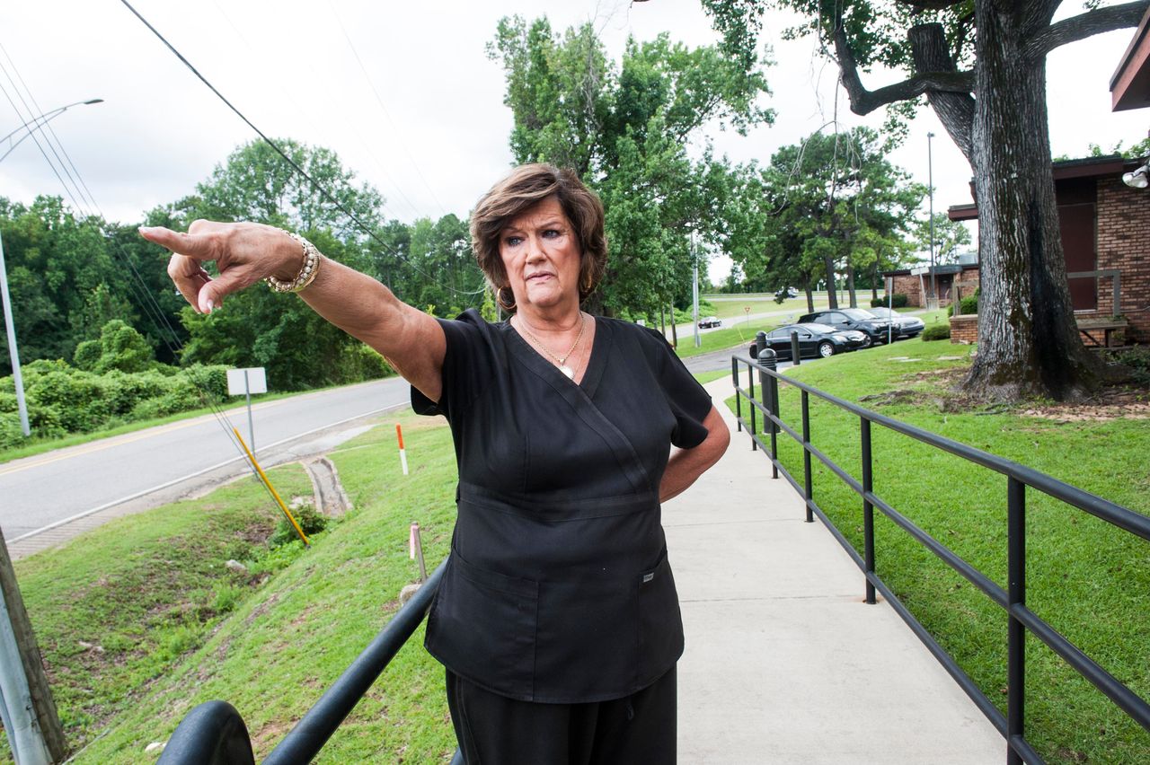 Abortion clinic owner Gloria Gray stands on the exit ramp she was legally required to build. She says it cost her about $150, 000 to comply with a state regulation about clinic exits.