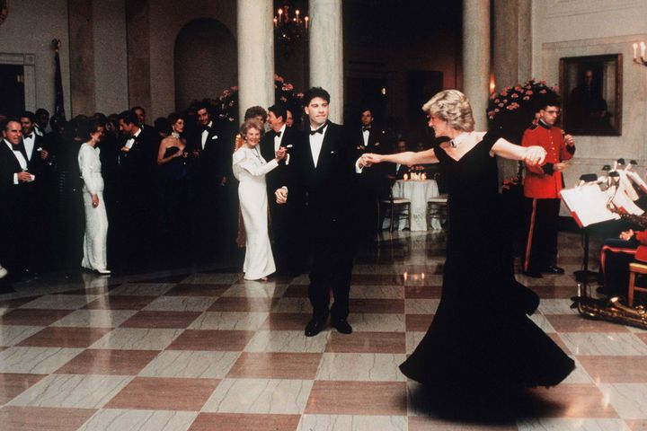 Diana dances with John Travolta at the White House in 1985 as President Ronald Regan and wife Nancy look on