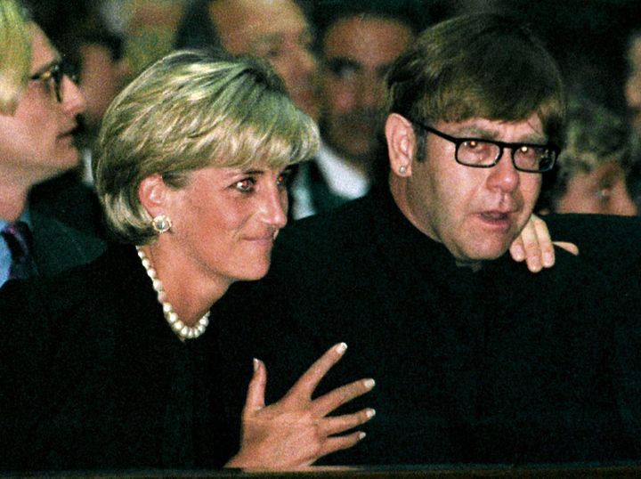 Diana comforting Elton John at a memorial mass for Italian fashion designer Gianni Versace at Milan Cathedral in July 1997