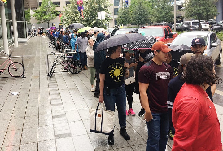 People wait in line to volunteer at George R. Brown Convention Center in Houston.