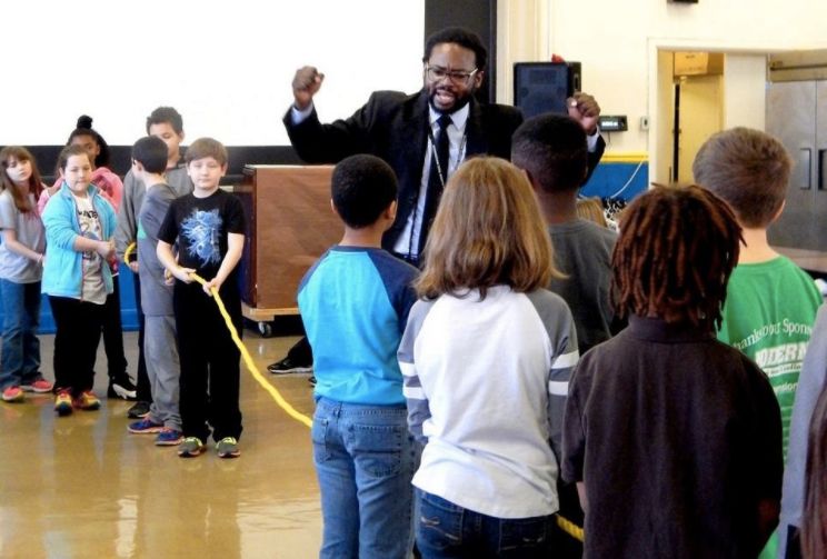 Charles Woods leads a class in an interactive "tug-of-war" game around the civil rights movement