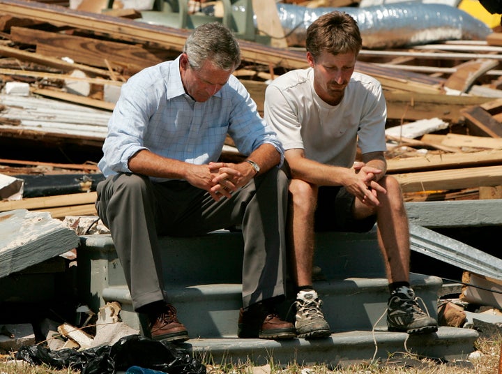 George Bush sitting with Biloxi resident Patrick Wright, whose home was destroyed during Hurricane Katrina in 2005. 