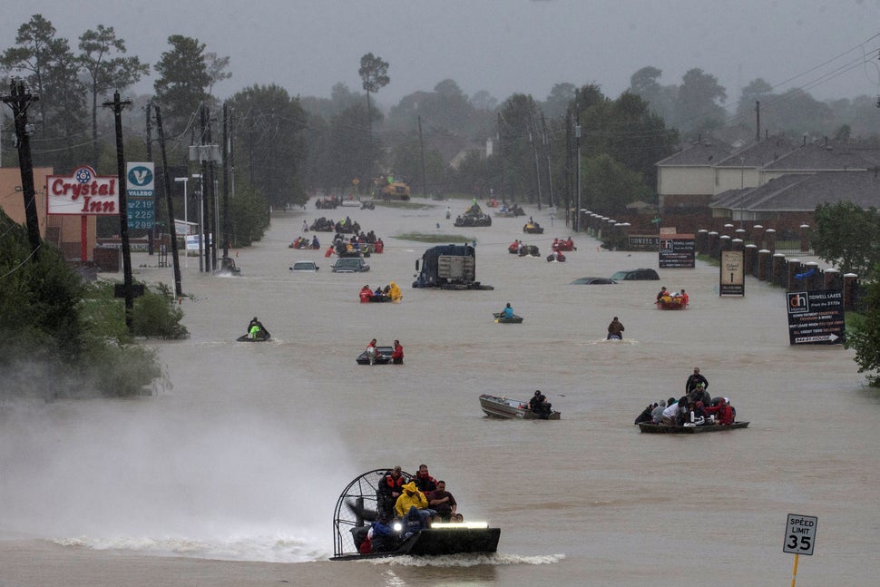 Residents use boats to evacuate from Tropical Storm Harvey along Tidwell Road in east Houston on Aug. 28.