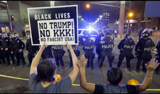 Aug. 22, 2017. Protesters raise their hands after Phoenix police used tear gas outside the Phoenix Convention Center. Demonstrations were held against President Trump as he hosted a rally inside the convention center. Matt York/AP. 