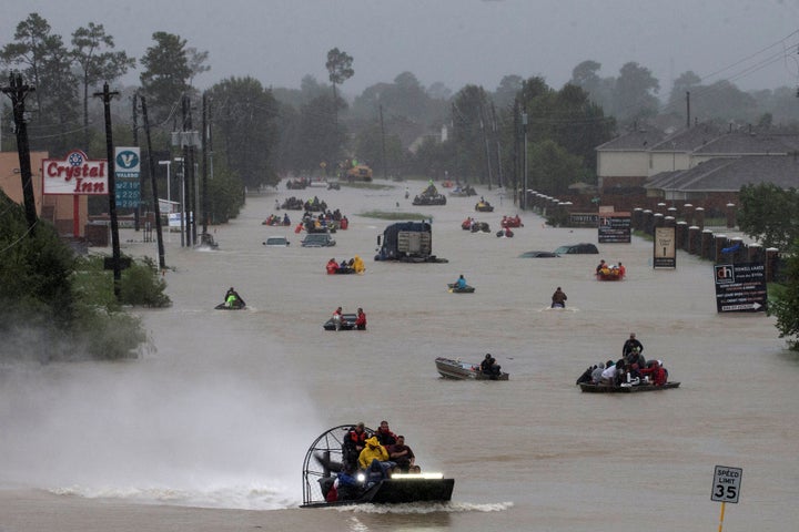 Residents use boats to evacuate flood waters along Tidwell Road east Houston, Texas, on Monday.