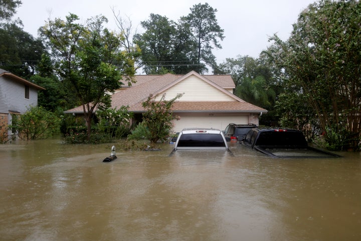Houses and cars are seen partially submerged by flood waters in east Houston on Monday.
