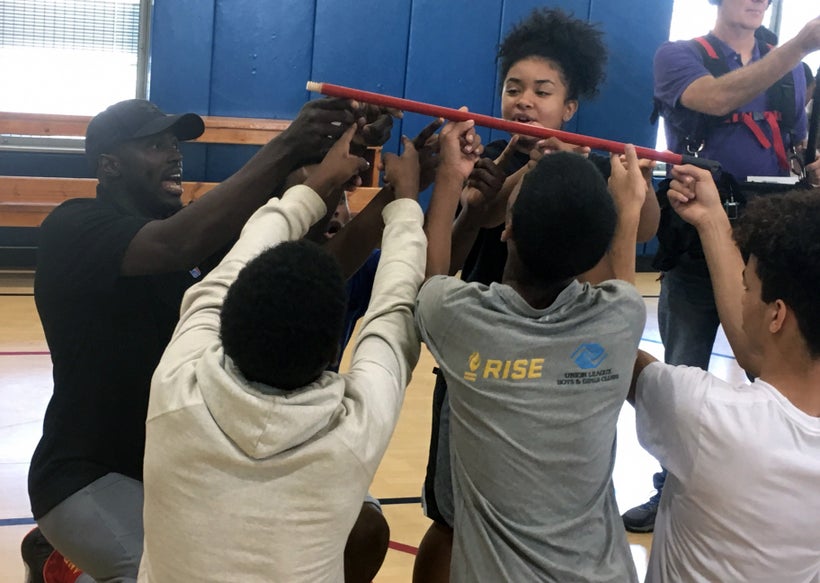 Chicago Bulls guard Jerian Grant helps student-athletes in the Building Bridges Through Basketball program with a teamwork ex