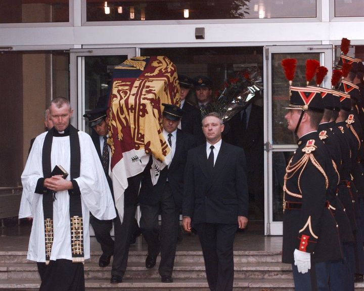 Pallbearers carry the Royal Standard-covered coffin containing the body of Diana from the Pitie-Salpetriere Hospital in Paris 