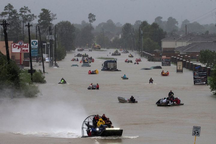 Residents use boats to evacuate flood waters from Tropical Storm Harvey in Houston, Texas, Monday.