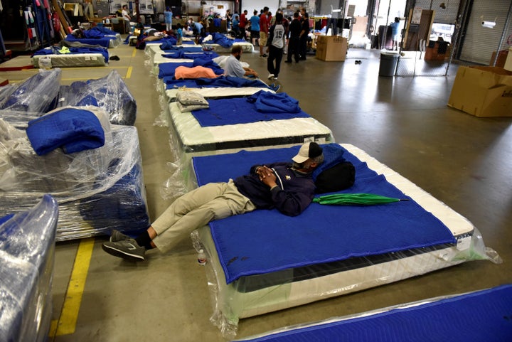 Evacuees get some rest in the warehouse at Gallery Furniture which opened its doors to residents needing shelter, in Houston, Texas.