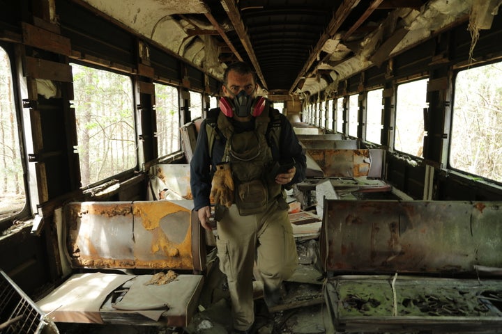<p>Philip Grossman on an abandoned train at the Chernobyl site.</p>