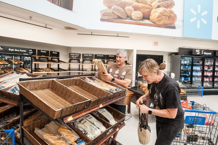 Don and Tammy Snowden, whose home just down the street from the Walmart in Katy, Texas, was flooded, pick up fresh-baked baguettes at the store.