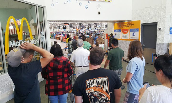 People wait to enter the Walmart in Katy, Texas, on Wednesday.