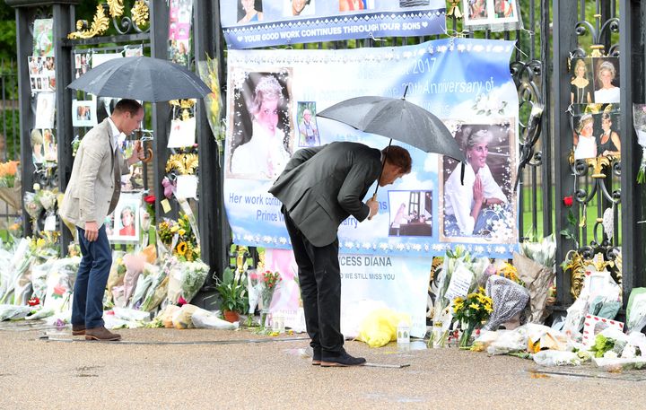 Prince Harry (right) and Prince William, Duke of Cambridge views tributes to Princess Diana.