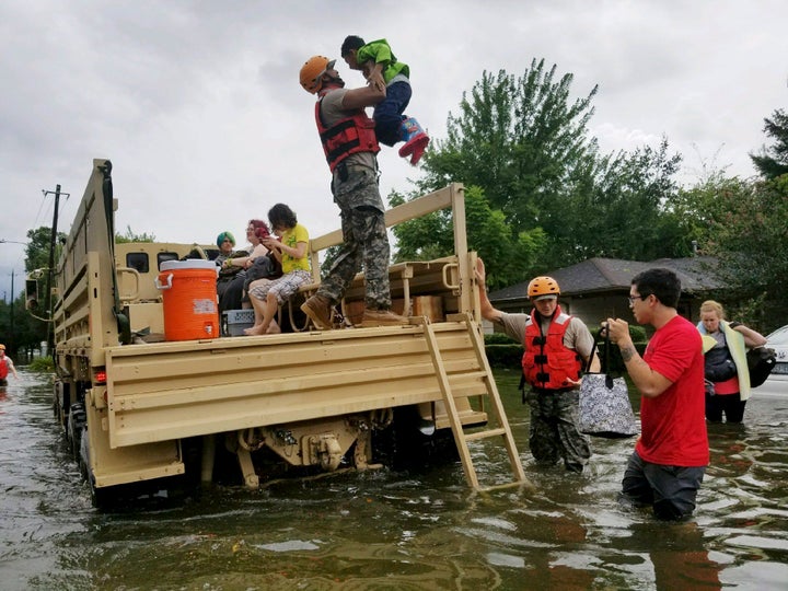 A photo made available by the Texas Military Department shows Texas National Guard soldiers arriving to aid citizens in heavily flooded areas in Houston.