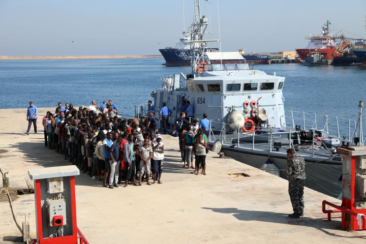 Migrants line up upon their arrival at a naval base after they were rescued by Libyan coastguard, in Tripoli, Libya 29 August.