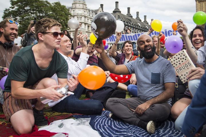 Dozens of protesters stage a mass inhalation of nitrous oxide outside the House of Parliament in August 2015, before the Psychoactive Substances Act came into force in May 2016