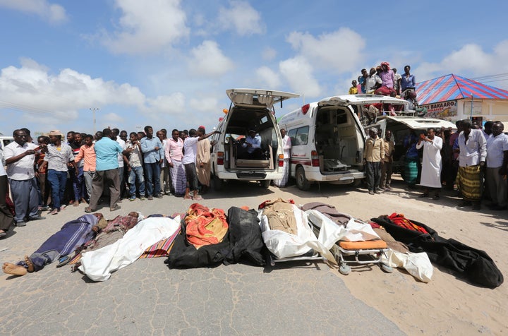 Relatives stand near the bodies of civilans killed in an attack by Somali forces and supported by U.S. troops on Aug. 25.