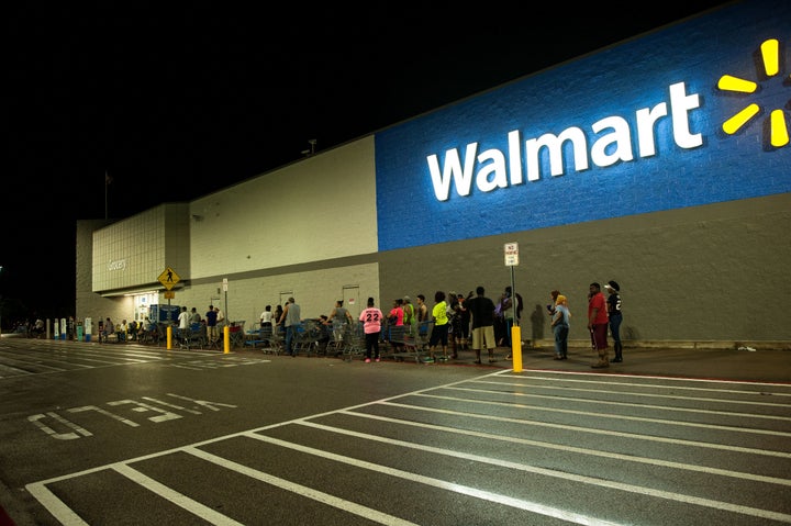 People wait in line early Thursday morning for a Beaumont, Texas, Walmart to open.