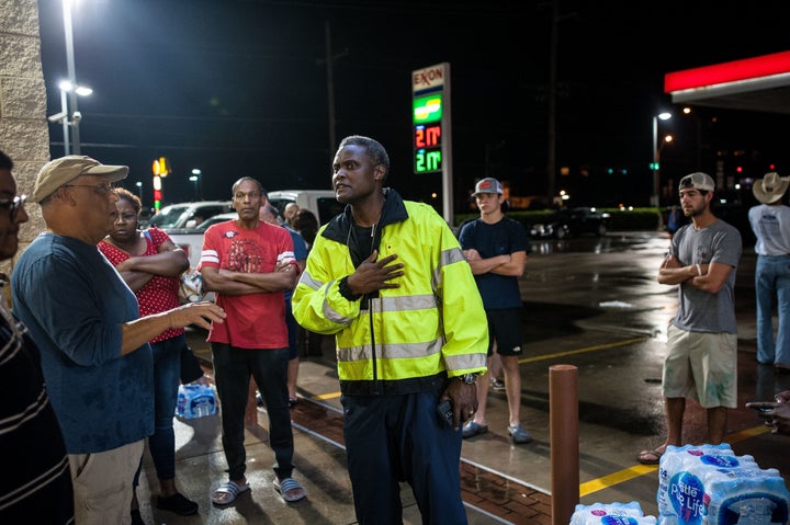 Beaumont ISD Police Chief Joe Malbrough attempts to stop people from taking water outside a local convenience store.