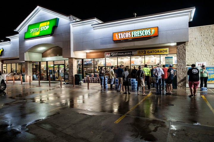 Beaumont residents wait outside a local convenience store after the city loses its water supply.