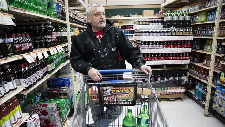 A customer shops for soda in Philadelphia, where beverages are subject to a new tax. The beverage taxes were aimed at sugary drinks, but beverage tax rules in states and cities are so complex that stores have taken to labeling which products are subject to the tax and which are not.