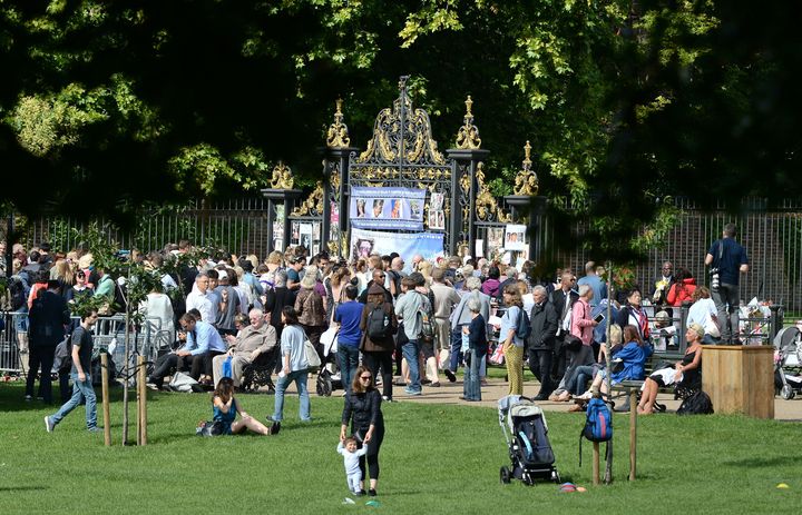 People gather outside Kensington Palace, in London, to mark the twentieth anniversary of the death of Diana, Princess of Wales.