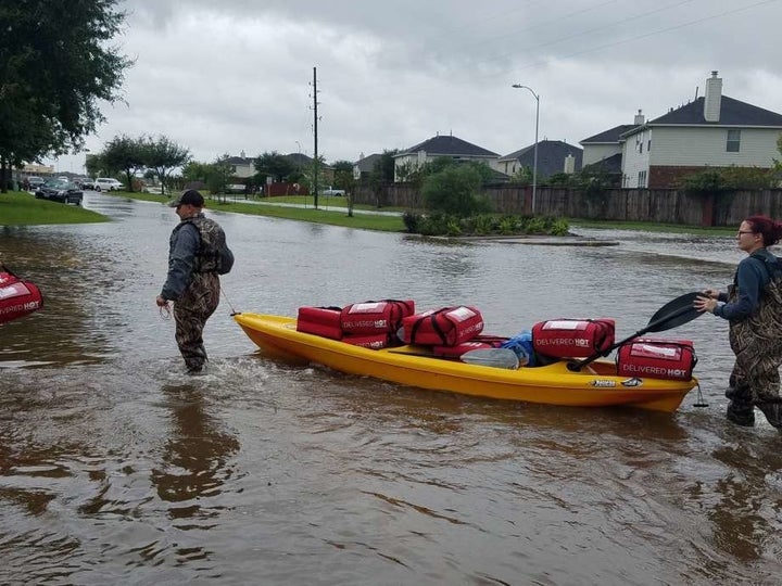 Pizza Hut employees deliver pizzas to flooded homes in southeast Texas this week.