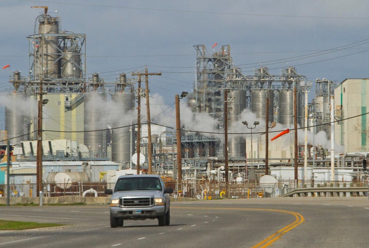 A pick-up truck drives along Independence Parkway near oil refineries and storage facilities south of downtown Houston Jan. 3